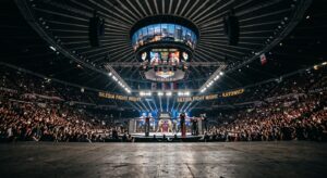 A cinematic, wide-angle shot of a modern, floodlit indoor arena in Silesia, captured from a low angl