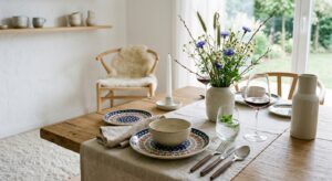 A professional, editorial-style photograph featuring a modern, minimalist dining table setting that