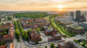 A professional, high-angle editorial shot of a modernizing Silesian town blending historic red-brick